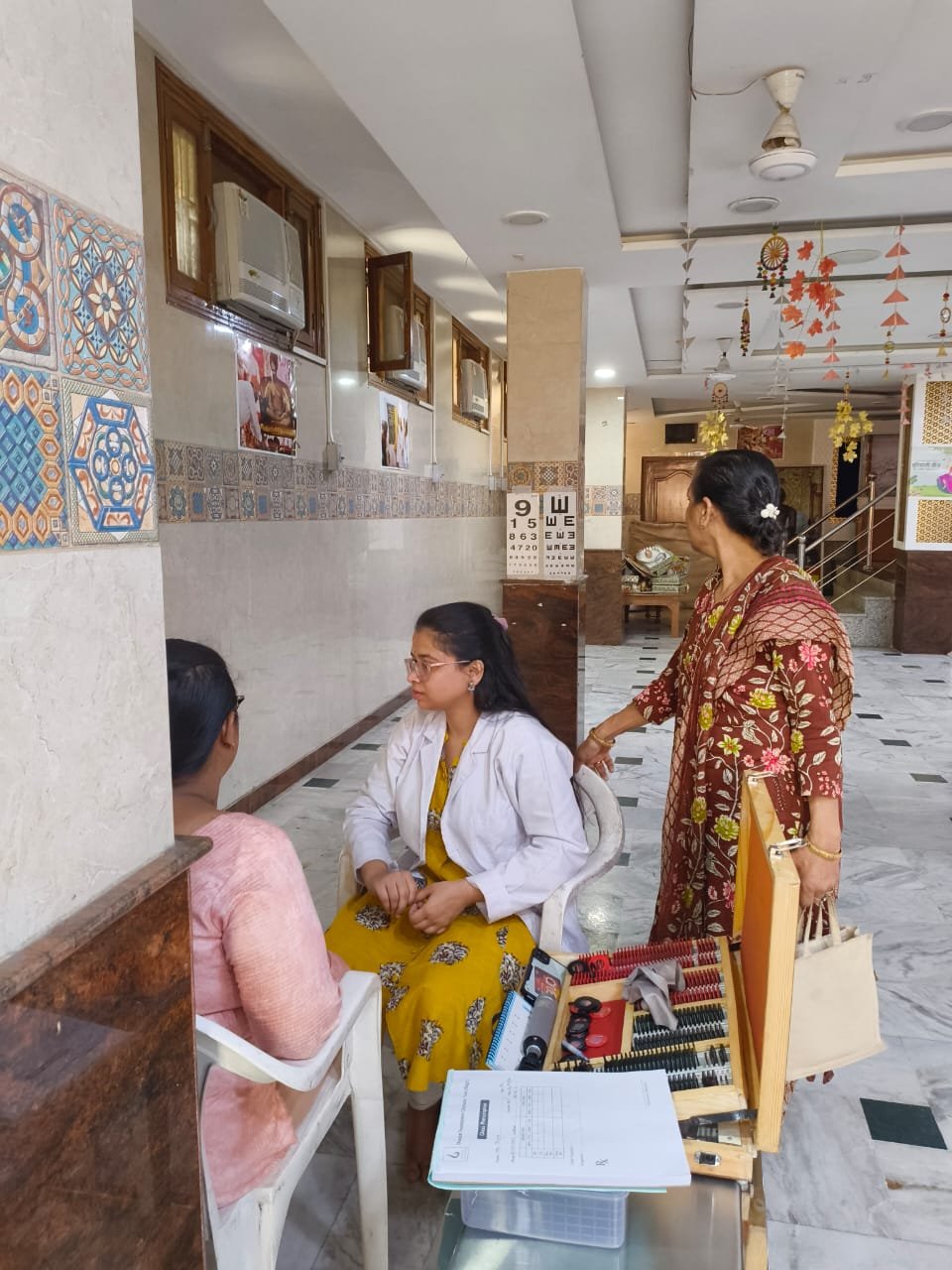 An optometrist conducting a vision test at Dharatal Foundation's eye care unit, Baghpat